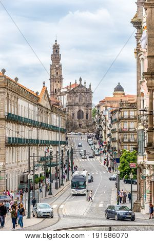 PORTO,PORTUGAL - MAY 13,2017 - In the streets of Porto - in the background Clerigos church. Porto is located along the Douro river estuary in Northern Portugal.