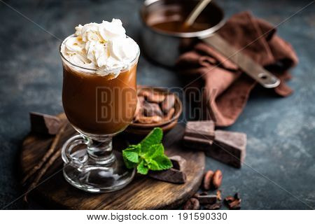 Iced cocoa drink with whipped cream cold chocolate beverage coffee frappe on dark background