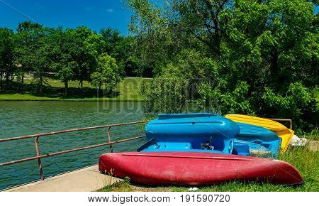 Old paddle boats and a canoe by the lake