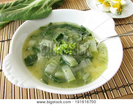 Homemade chard cream soup in white bowl