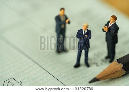 Miniature people small figure businessman standing on bank account book and others clapping as business financial concept.
