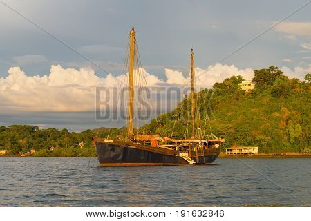 Hell-Ville Madagascar - December 19 2015: SV Ooskus vessel in the rays of the setting sun anchored at Andavakotakona Bay near Hell-Ville Nosy Be Island Madagascar.