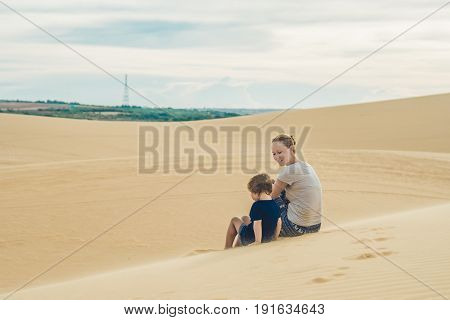 Mom And Son In The Desert. Traveling With Children Concept