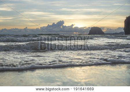 Cloudscape and waves at the beach during sunset, Charlies beach, hat farang at Koh Mook Thailand