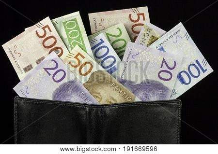 Wallet with Swedish Krona Currency on black background.