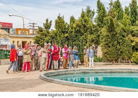 YAZD, IRAN - MAY 5, 2015: Group of tourists visiting the fire temple Atash Behram in old city.
