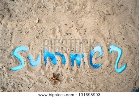 Inscription summer on a sunny sandy beach