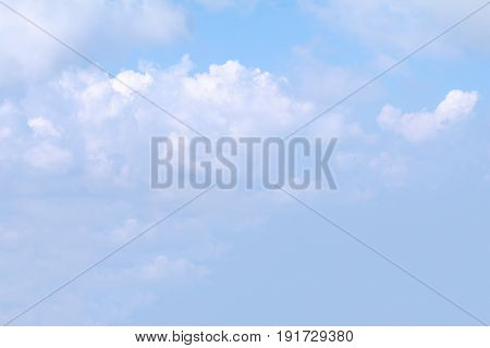 Clear blue sky background with white clouds.