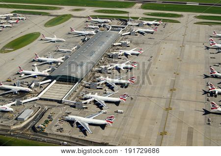 LONDON UK - JUNE 3 2017: Aerial view of British Airways planes parked at Terminal 5 of London's Heathrow Airport on a sunny summer morning.