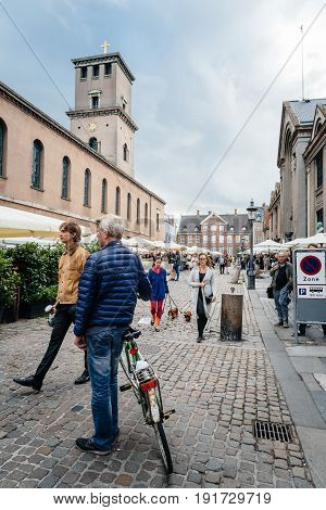 Copenhagen Denmark - August 11 2016. People in antiques flea market in Frue Square in Copenhagen. Frue Plads is a public square located on the north side of the Church of Our Lady in central Copenhagen