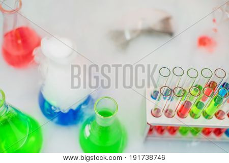 Laboratory expreriment with test-tubes with colored chemical reagents, retorts and flasks