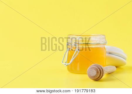 Jar of Honey with Honey Dipper on yellow