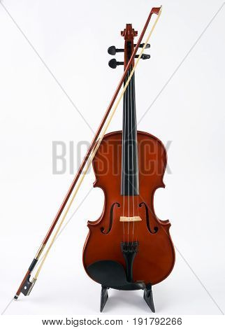 Violin with bow isolated on white background. Classical stringed musical instrument fiddle with fiddlestick.