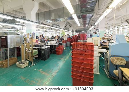 MOSCOW, RUSSIA - FEBRUARY 21, 2017: Moscow shoe factory JSC RALF RINGER . Female and male workers on a sewing machine.