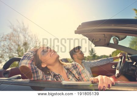 Couple of lovers driving on a convertible car - Newlywed pair on a romantic date.