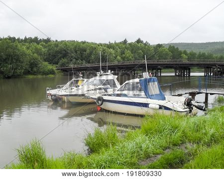 Motor Boats Are At The Pier On The River. The River Pier.