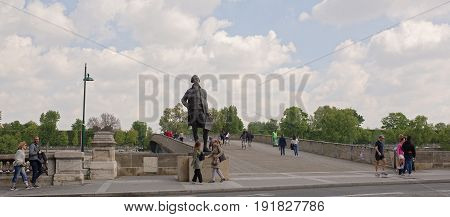 ParisFrance- April 29 2017: Monument to Jefferson at Bridge Leopold Sedar Senghor. Citizens go and ride their bicycles on their own business