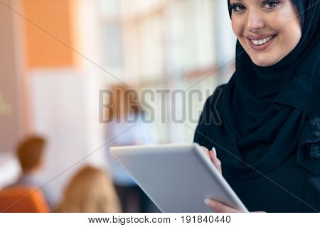 beautiful Arabian girl with tablet computer working at startup office.