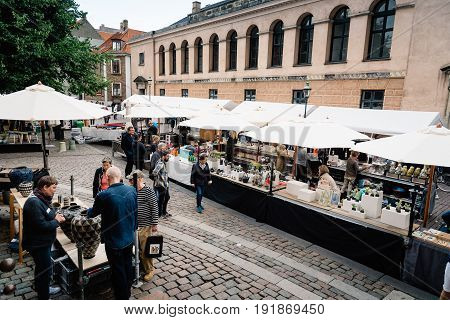 Copenhagen Denmark - August 11 2016. People in antiques and artisans street market in Frue Square in Copenhagen. Frue Plads is a public square located on the north side of the Church of Our Lady in central Copenhagen