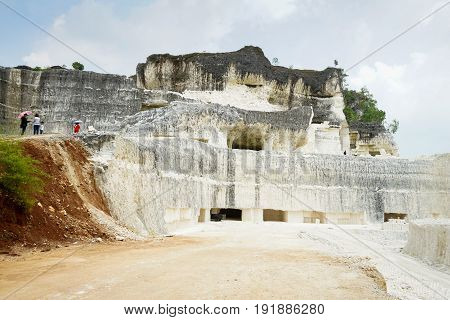 The exploitation of limestone hills forming a unique architectural in Jeddih or Jaddih Hill Madura Island, Indonesia