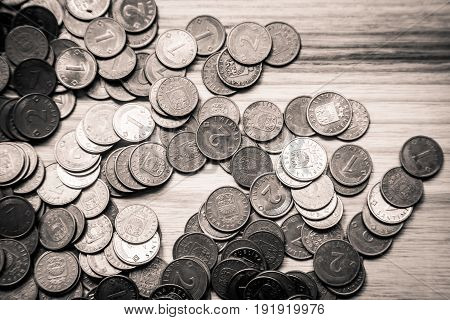 Old Latvian Coins On A Wooden Background - Monochrome Vintage Look