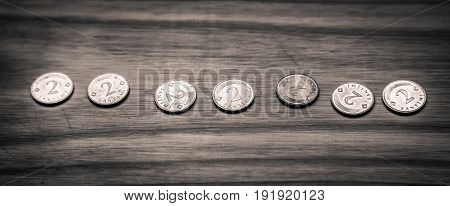 Old Latvian Coins On A Wooden Background - Monochrome Vintage Look