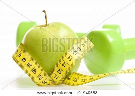 Tape For Measuring In Yellow Color Wrapped Around Green Apple