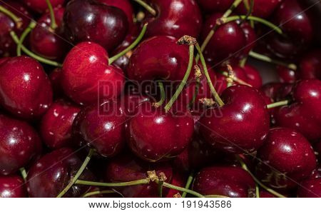 cherry detail macro of delicious fresh ripe red cherries with bright green stem, perfect food background Sweet cherry background
