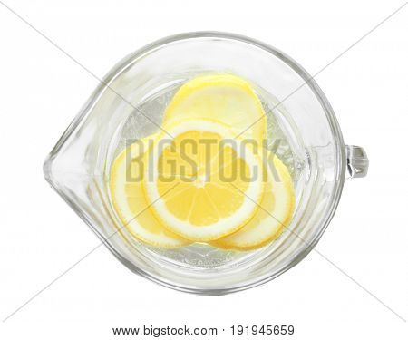 Tasty refreshing lemonade in glass jug on white background