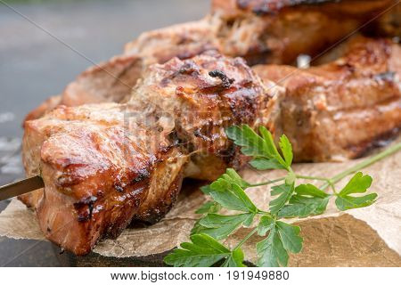Grilled shish kebab or shashlik pork meat on skewers closeup on white background