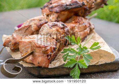Grilled shish kebab or shashlik pork meat on skewers closeup on white background