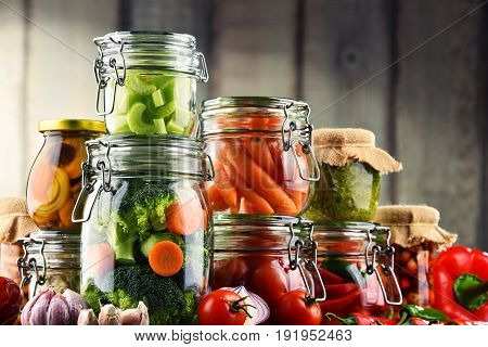 Jars With Marinated Food And Organic Raw Vegetables