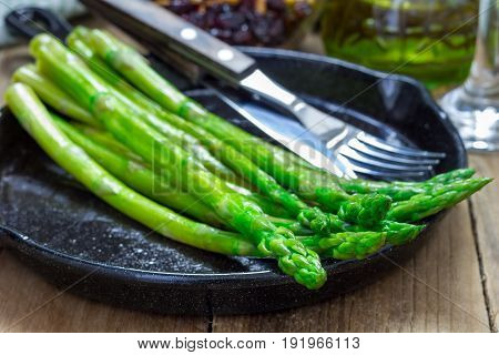 Freshly cooked asparagus appetizer on a cast iron skillet