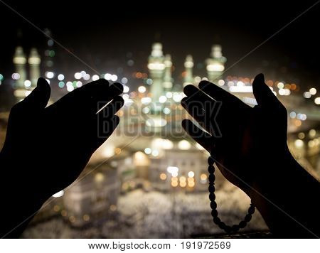 Muslim hands praying in Kaaba
