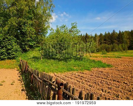 Rural landscape, Old wooden fence in the country, Belarus - May 2017