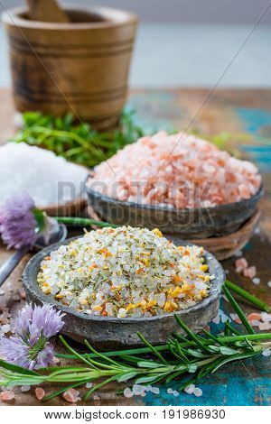Three Different Types Of Natural Salt In Stone Bowls On Wooden Surface. White Sea Salt, Pink Himalay
