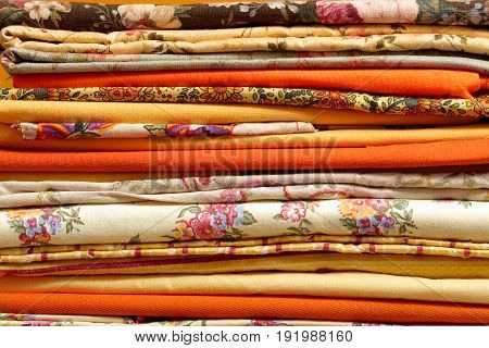 a stack of the beautiful  multicolored fabrics