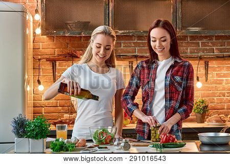 Good Food Is All The Sweeter When Shared With Good Friends. Young Female Friends Preparing Together 
