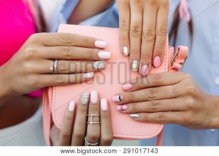 Close Up Of Bag With Girls Hands With Manicure Over It.