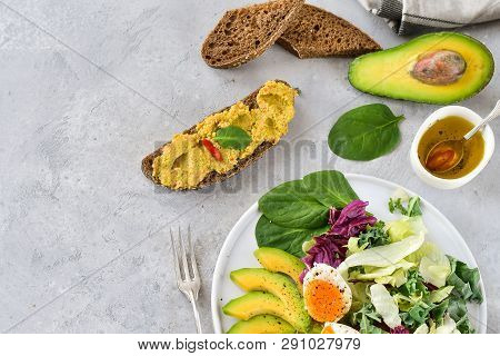 Salad Of Avocado, Kale Leaves, Egg And Spinach, On A White Plate, Grain Bread, Diet Food, Organic Ve