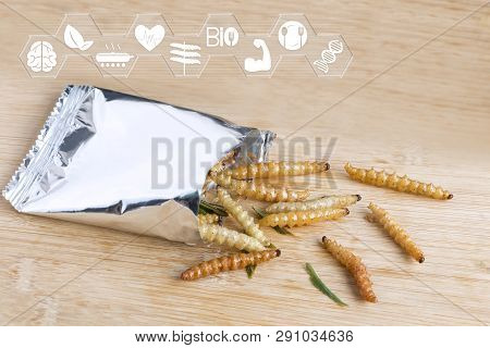 Bamboo Worm Insects For Eating As Food. Bamboo Caterpillar Deep-fried Crispy Snack In A Foil Wrap Re