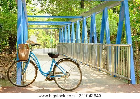 Bangkok, Thaialnd - March 21,2019 : A Lady Vintage Bicycle Parking In Front Of The Small Blue Bridge