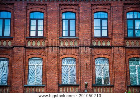 The Facade Of The Building Of Red Bricks With Windows