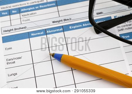 Page Of Health History Form With Pre-participation Physical Information. There Are Glasses And Ballp