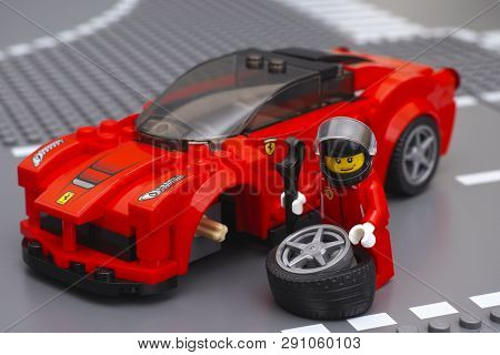 Tambov, Russian Federation - March 05, 2015 Lego Driver Minifigure Is Fixing Wheel Of Laferrari By L