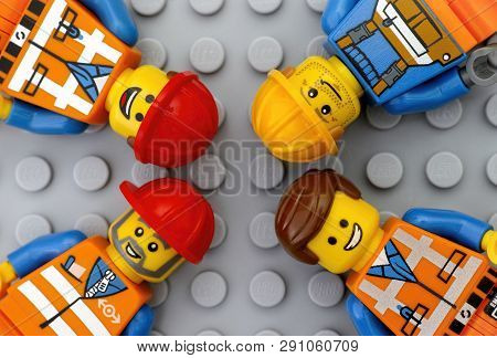 Tambov, Russian Federation - May 12, 2016 Four Lego Workers Minifigures On Lego Gray Baseplate Backg