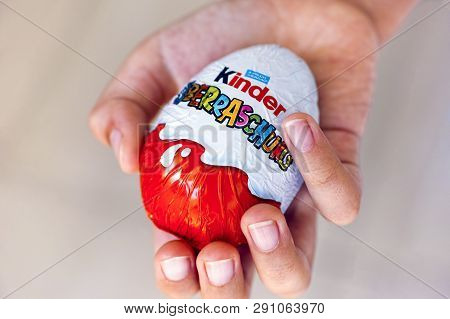 Paphos, Cyprus - November 21, 2016 Child Hand With Kinder Surprise Egg. Word Surprise Written In Ger