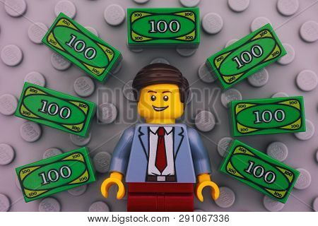 Tambov, Russian Federation - June 22, 2017 Lego Businessman And Lego Money On Gray Baseplate Backgro