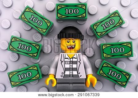 Tambov, Russian Federation - June 22, 2017 Lego Criminal And Lego Money On Gray Baseplate Background