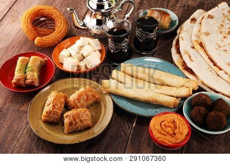 Middle Eastern Or Arabic Dishes And Assorted Meze, Concrete Rustic Background. Turkish Bread Or Turk
